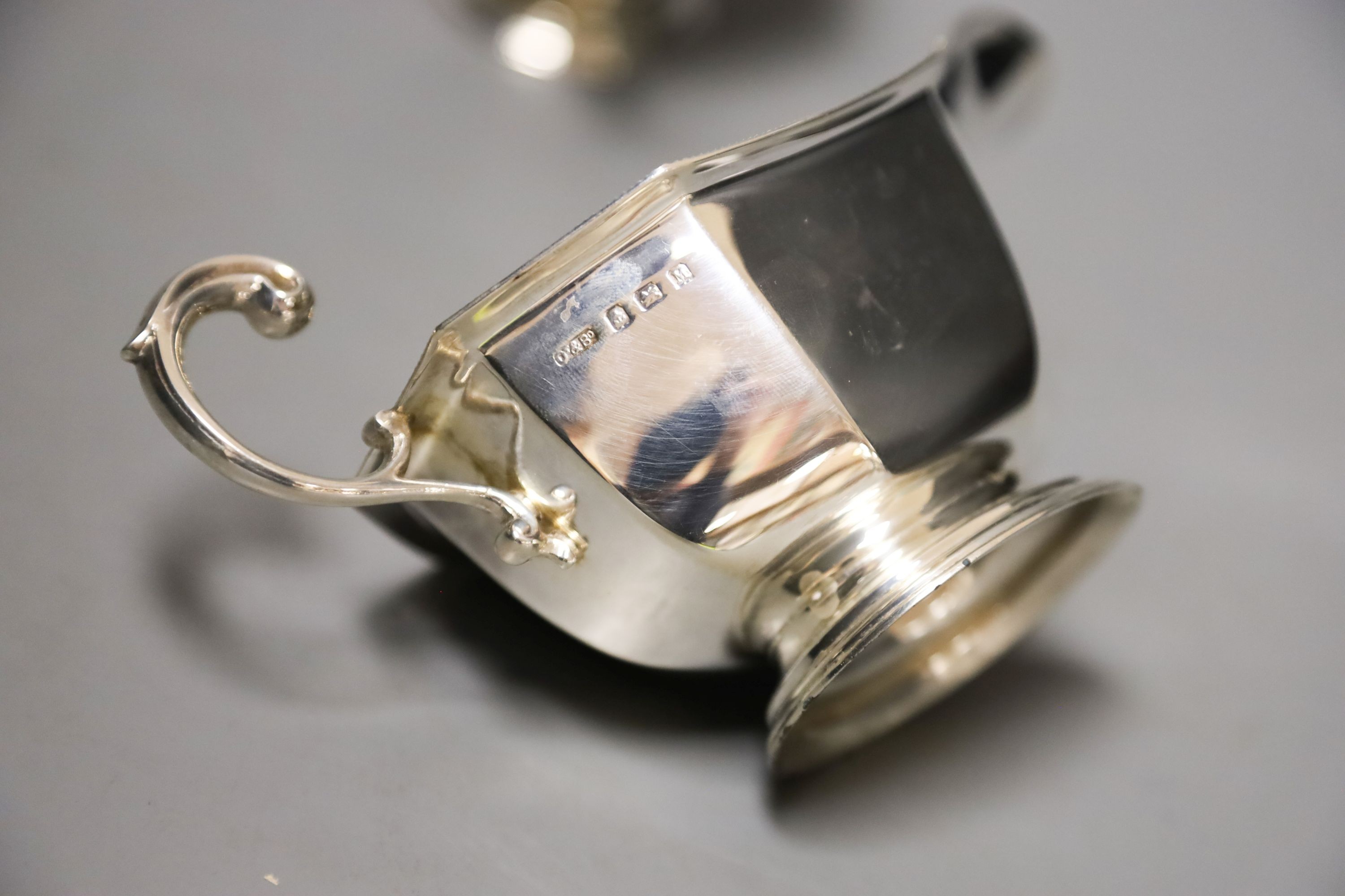 A pair of 1930's silver sauceboats, with flying scroll handles, 16.2cm, 8oz.